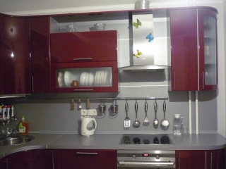 Угловая кухонная мебель красного цвета